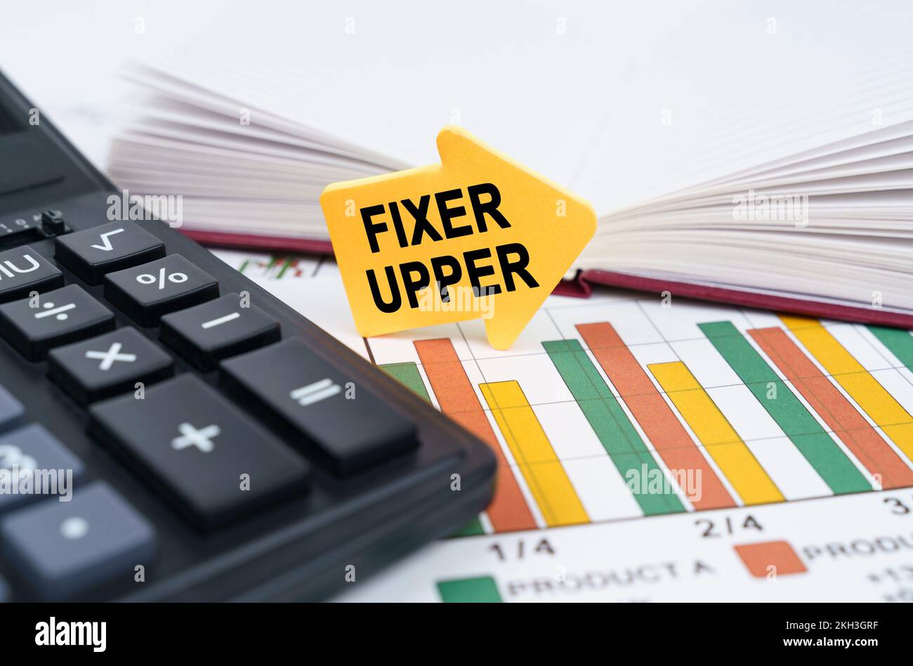 Concetto aziendale. Sui grafici di affari ci è un blocco note, una penna ed un adesivo della freccia con l'iscrizione - il fixer superiore Foto Stock