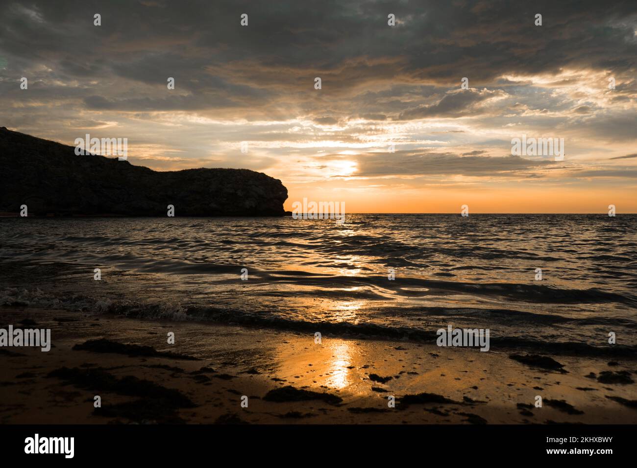 Onde sul mare durante il tramonto. Relax, divertimento. Viaggio verso l'oceano, pace e felicità. Colorato, luminoso, arancio tramonto. Il sole splende attraverso le nuvole sull'oceano. Splendidi sfondi per il tuo telefono. Riprese in 4K di alta qualità. Foto Stock