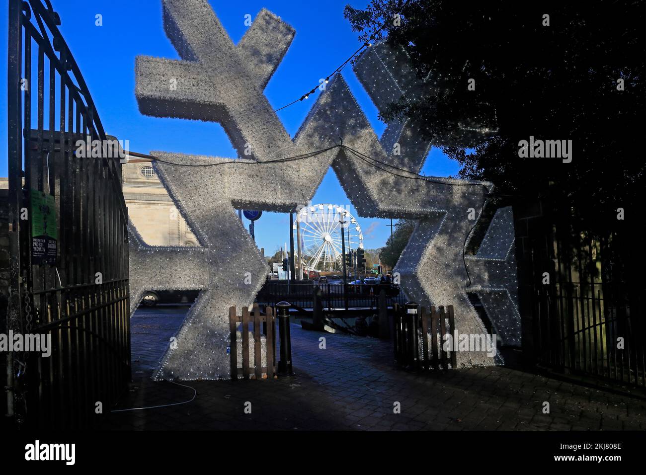 Ruota panoramica vista attraverso la forma di una stella di ghiaccio e ingresso al Cardiff Winter Wonderland, Cardiff. Preso il 2022 novembre. Inverno / autunno. Foto Stock