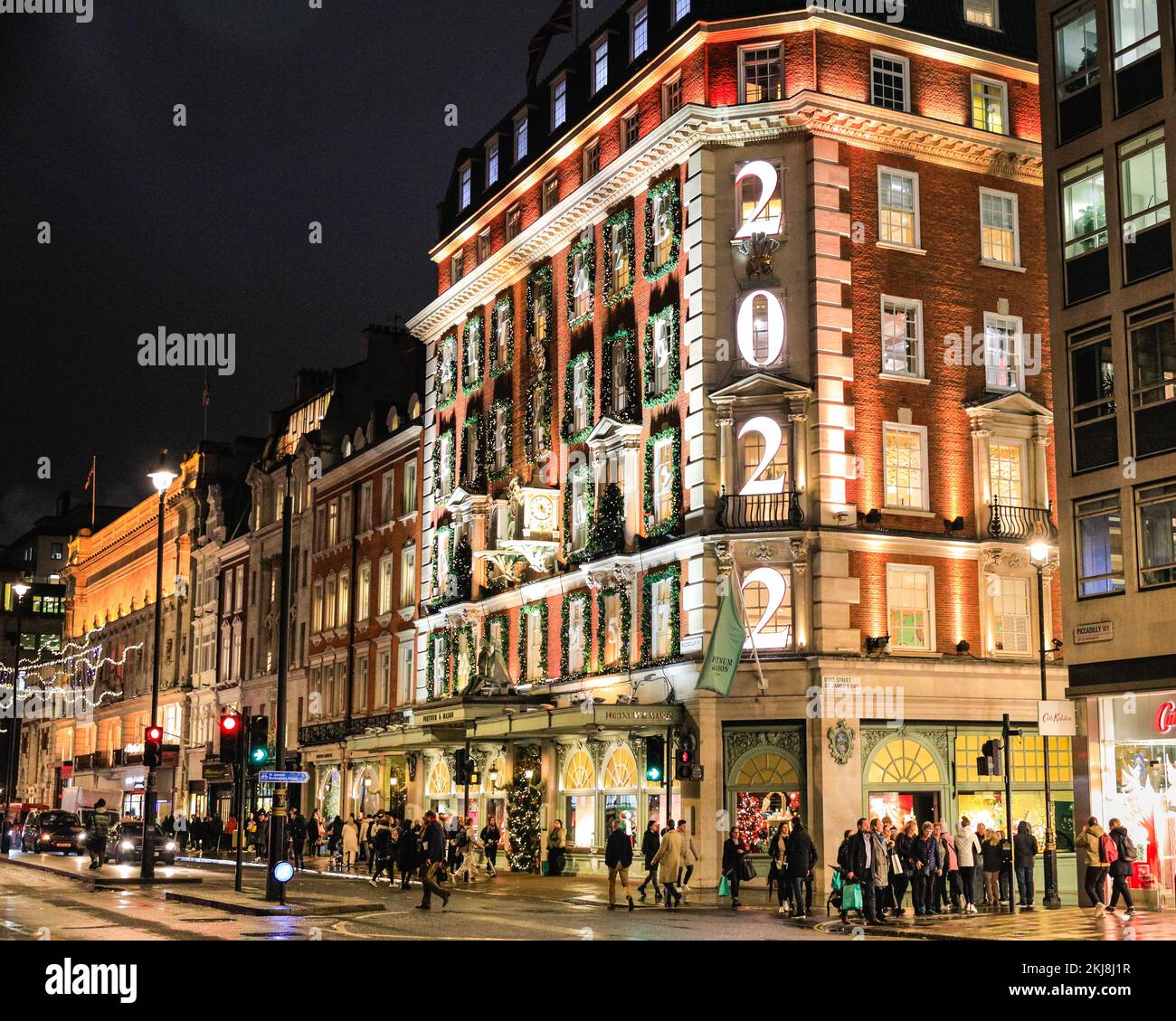 Londra, Regno Unito. 24th Nov 2022. La maggior parte dei grandi magazzini Fortnum & Mason è decorata per sembrare un gigantesco calendario dell'avvento, con l'anno, 2022, presentato all'angolo. La gente di Bond Street, la famosa strada dello shopping di Mayfair, e lungo Piccadilly curiosano tra le vetrine dei negozi e ammirano le numerose mostre colorate e le elaborate decorazioni a tema natalizio nei negozi di lusso di Mayfair. Credit: Imageplotter/Alamy Live News Foto Stock