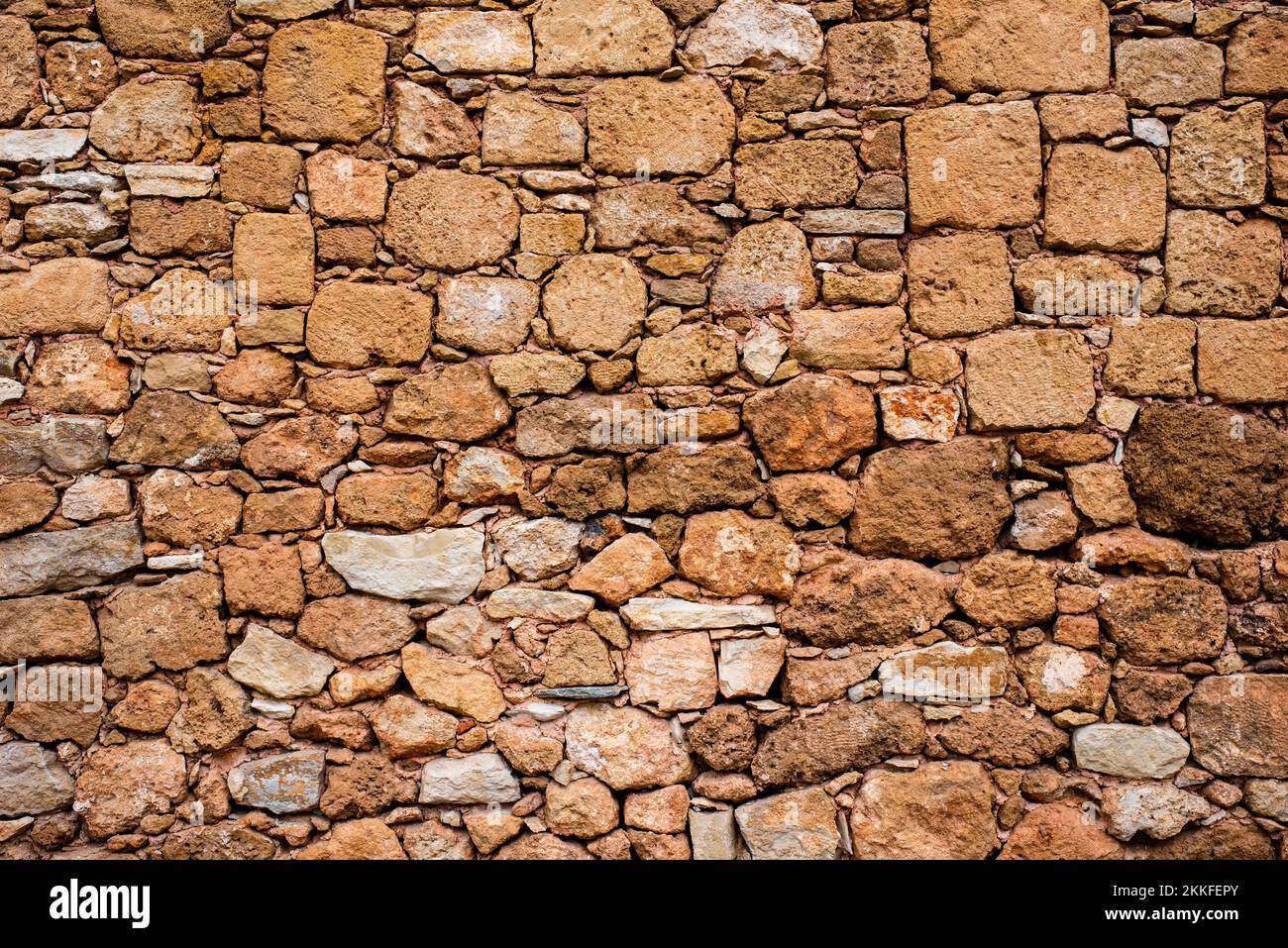 Sfondo. Muro di pietra. Mattoni gialli. Muro di pietre gialle. ripetizione. Foto Stock
