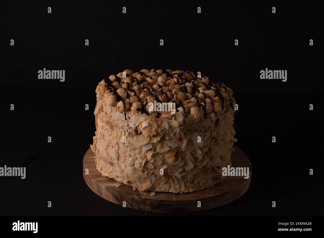 torta di noce fotografica su un asse di legno come visto dal lato Foto Stock