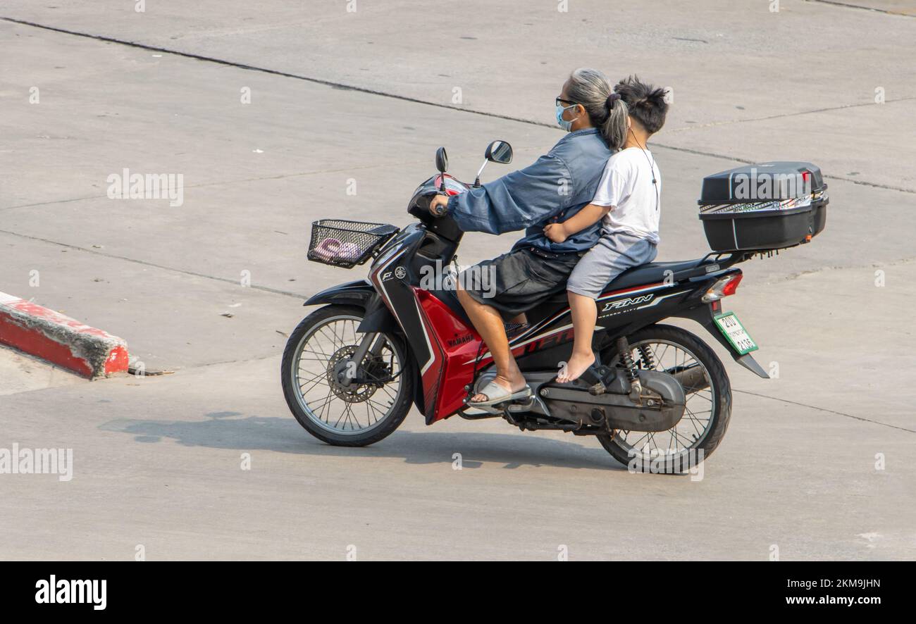 SAMUT PRAKAN, THAILANDIA, 02 2022 MARZO, una donna anziana cavalca un ragazzino in moto Foto Stock