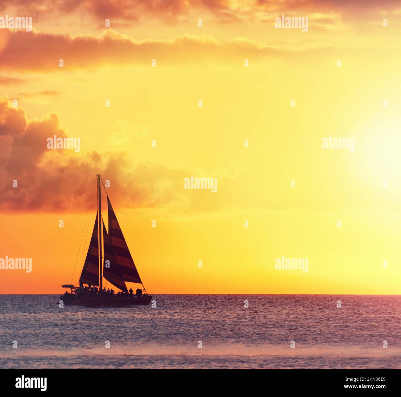 Una foto del tramonto a Waikiki, Honolulu, Hawaii. una barca a vela sull'oceano contro il sole tramontato. Foto Stock
