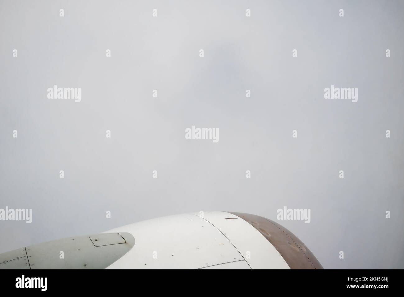 Vista da Boeing su Thick Gray Clouds, il cielo non è visibile. Alloggiamento motore bianco-grigio nel telaio con palette. Foto Stock
