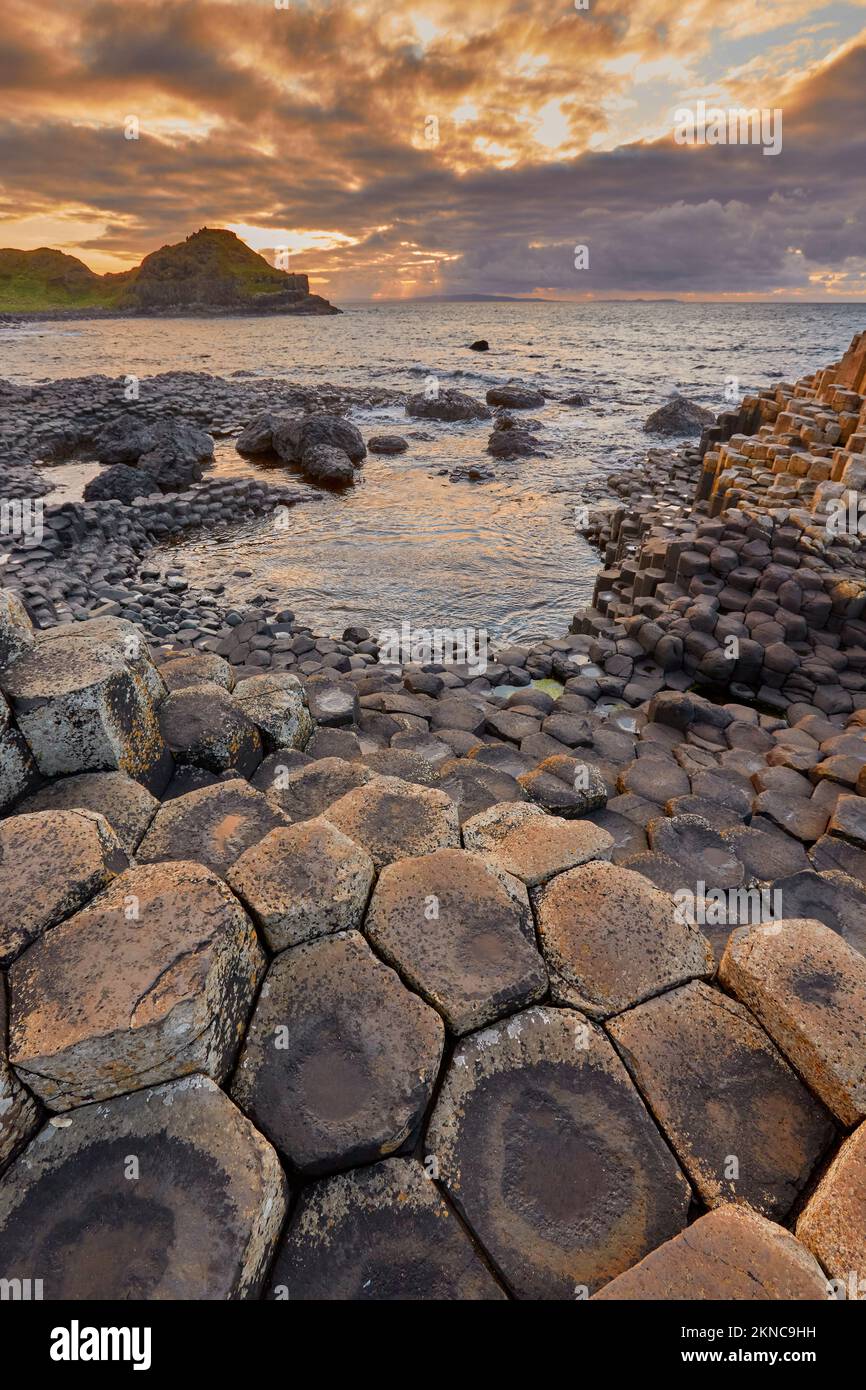 Costa atlantica con colonne vulcaniche di basalto esagonale del Selciato del Gigante al tramonto in Irlanda del Nord Foto Stock