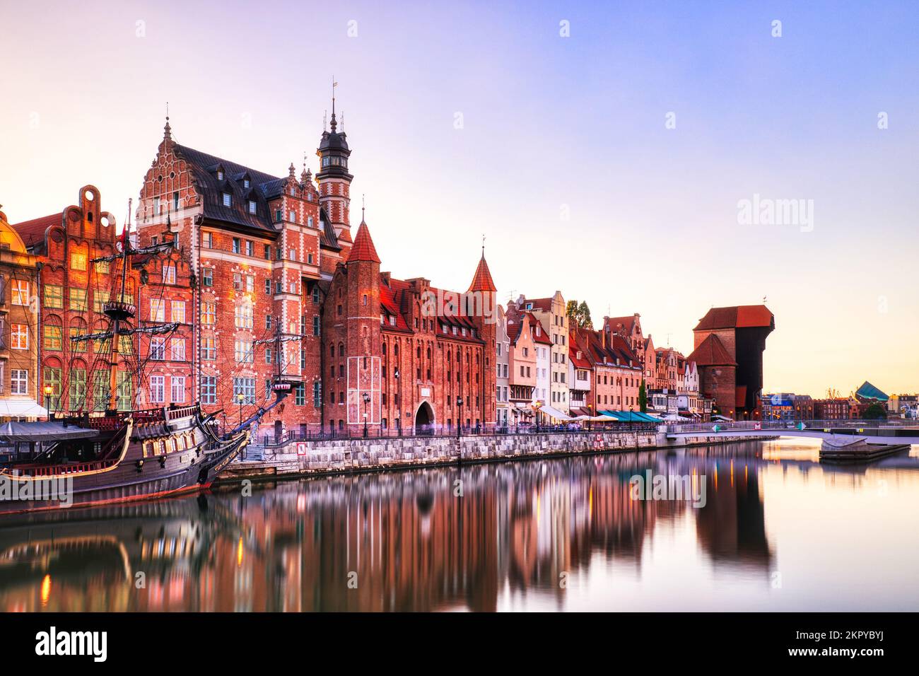 Illuminata la città vecchia di Danzica con il tranquillo fiume Motlawa al tramonto, Polonia, Europa Parole chiave: pol Foto Stock