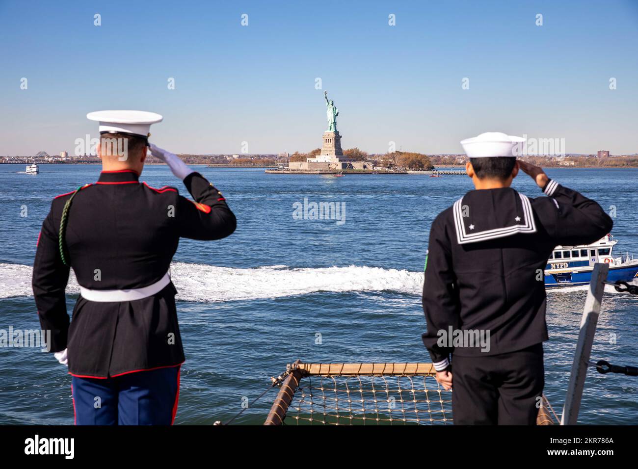 NEGLI STATI UNITI Navy Sailor è collegata alla nave portuale anfibia di San Antonio USS Arlington (LPD 24) e agli Stati Uniti Marine attaccata alla II Marina Expeditionary Force salutano la Statua della libertà quando Arlington arriva a New York City, 9 novembre 2022. I marinai e i marines di Arlington partecipano agli eventi a New York e nei dintorni durante la celebrazione della settimana Veterans Day di New York per onorare il servizio e il sacrificio dei veterani della nazione. Foto Stock