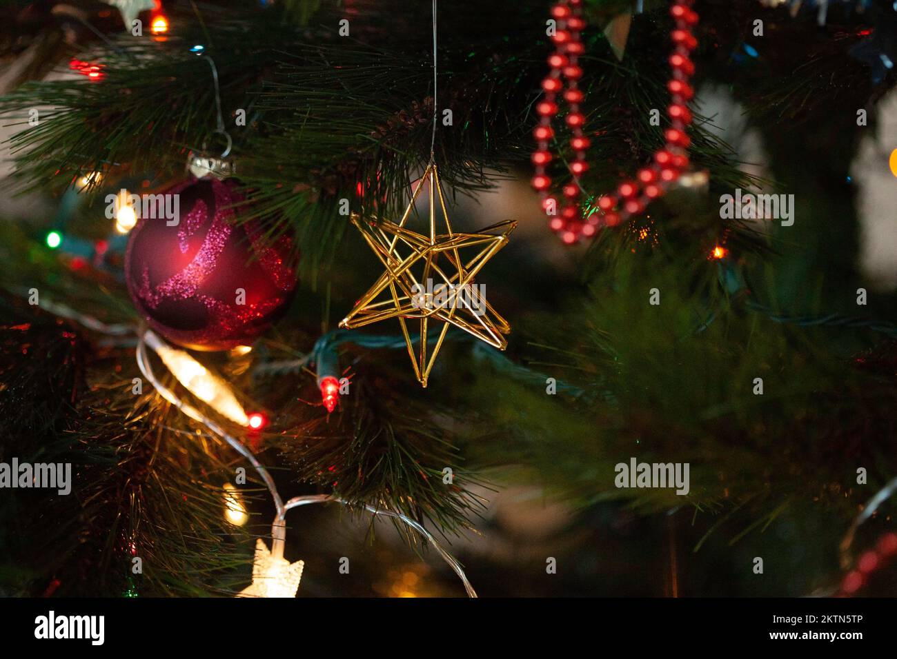 Uno sfondo di decorazioni albero di Natale ha luci colorate e ornamenti. Foto Stock