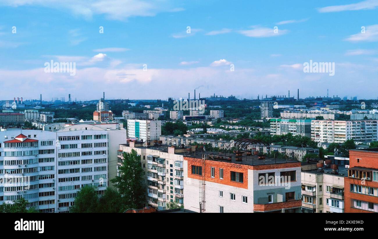 Panorama di una città industriale con molti edifici e fabbriche di camino all'orizzonte Foto Stock