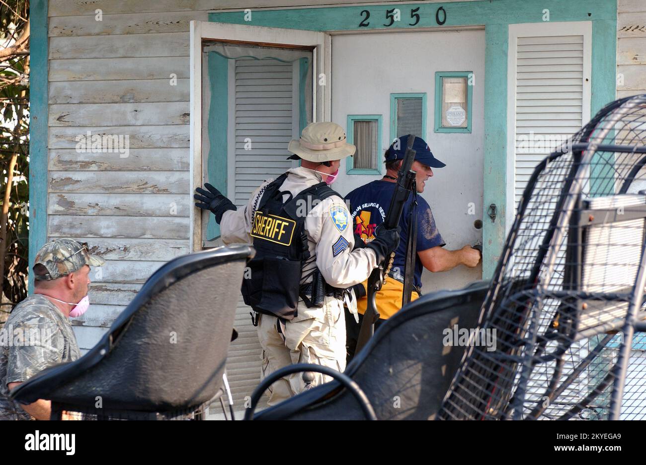 Uragano Katrina, New Orleans, LA, 10 settembre 2005 -- i membri di ricerca urbana e salvataggio di FEMA cercano i residenti colpiti dall'uragano Katriana. Sono accompagnati da funzionari incaricati dell'applicazione della legge. Jocelyn Augustino/FEMA Foto Stock