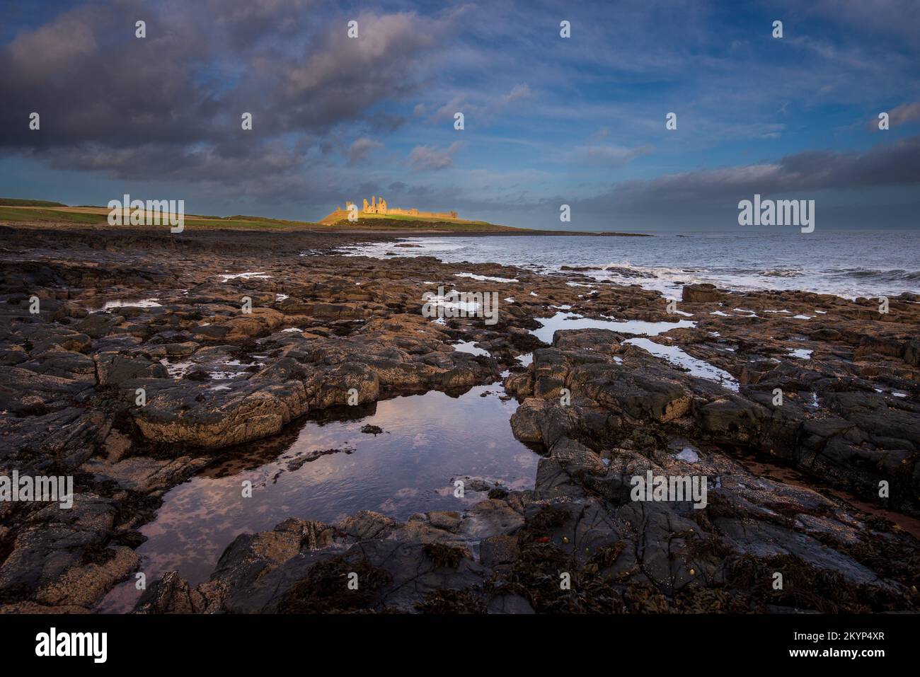 Dunstanburgh Castle vicino a Croster sulla costa del Northumberland, Inghilterra, Regno Unito Foto Stock