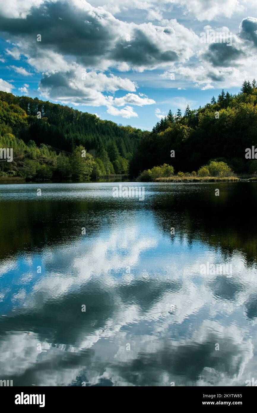 Riflessi di nuvole nel lago di Marcenat. Cantal. Auvergne Alpi del Rodano. Francia Foto Stock