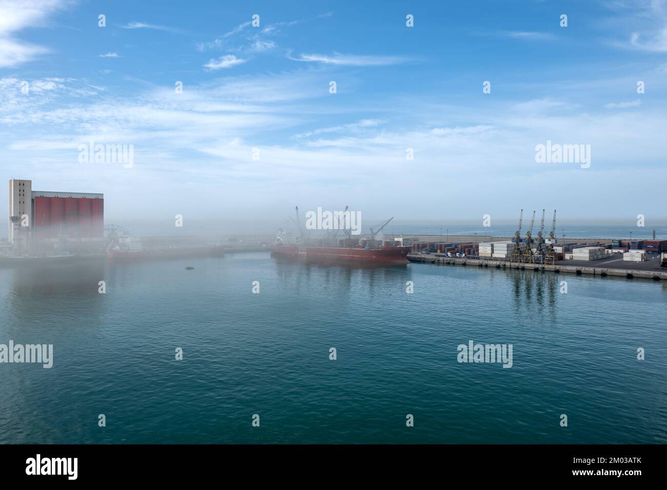 Porto industriale di Agadir con nave al molo (scarsa visibilità a causa di polvere, sabbia, ecc.) Foto Stock