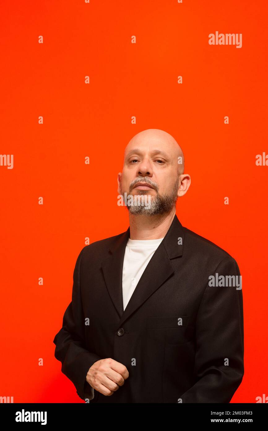 Uomo d'affari, di successo, elegante, calvo e bearded. Isolato su sfondo arancione. Foto Stock
