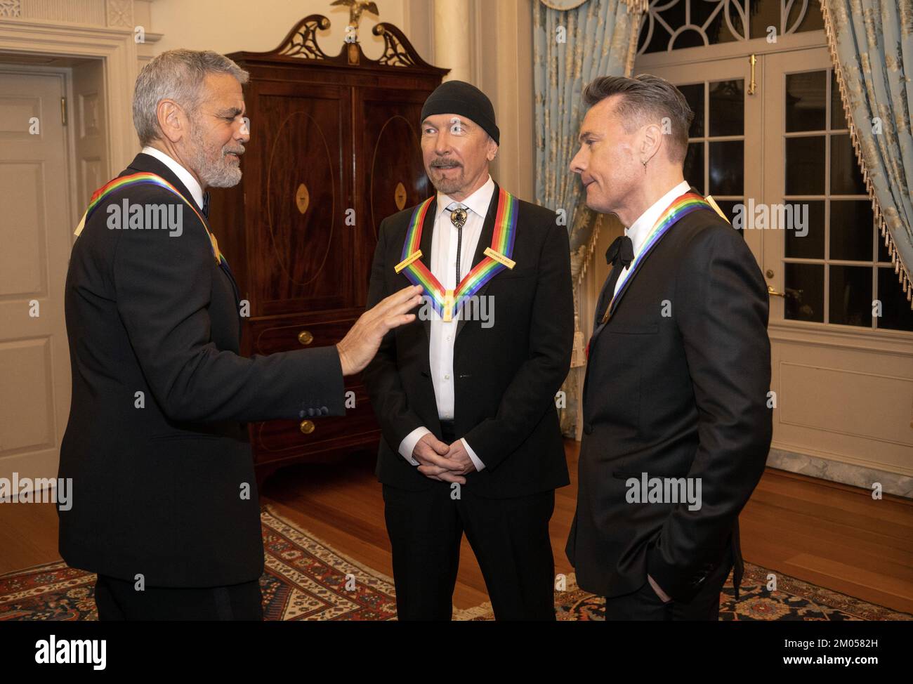 Washington DC, Stati Uniti. 03rd Dec, 2022. George Clooney, a sinistra, chiacchiera con gli altri destinatari The Edge, al centro, , a destra, in attesa di posa per una foto di gruppo dopo la cena degli artisti al Dipartimento di Stato degli Stati Uniti a Washington, DC Sabato, 3 dicembre 2022. Credit: UPI/Alamy Live News Foto Stock