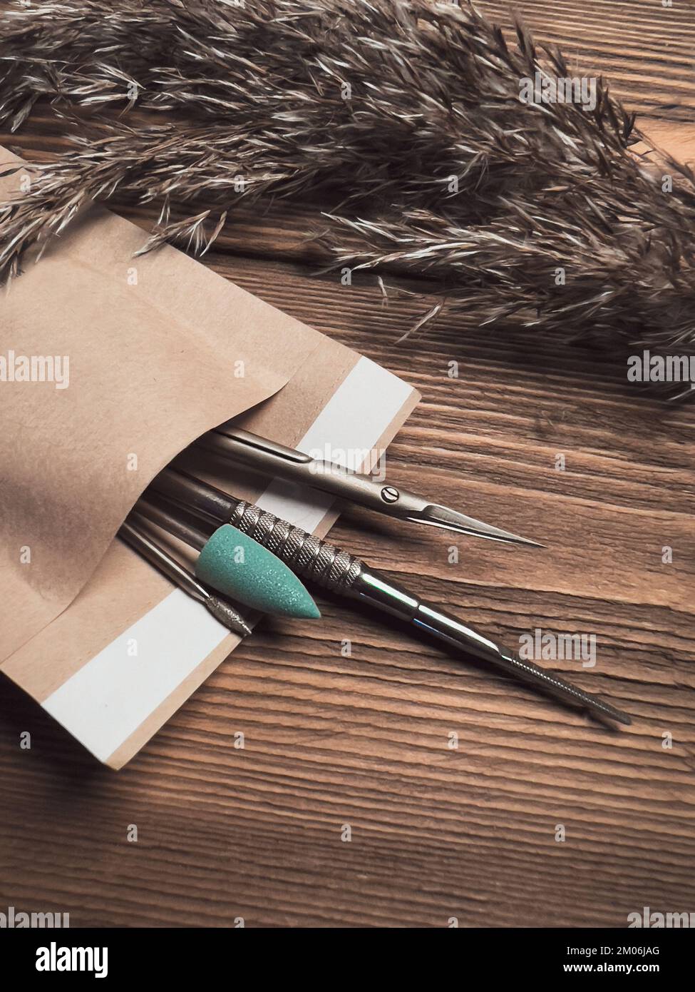 Un set di utensili per manicure sterili in un pacchetto artigianale. Salone delle unghie. Foto Stock