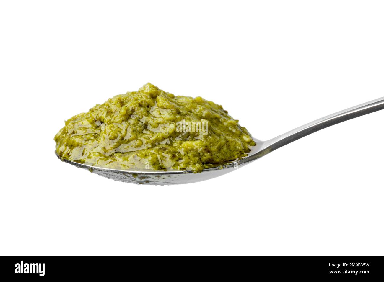 Cucchiaio con pesto verde italiano isolato su fondo bianco Foto Stock