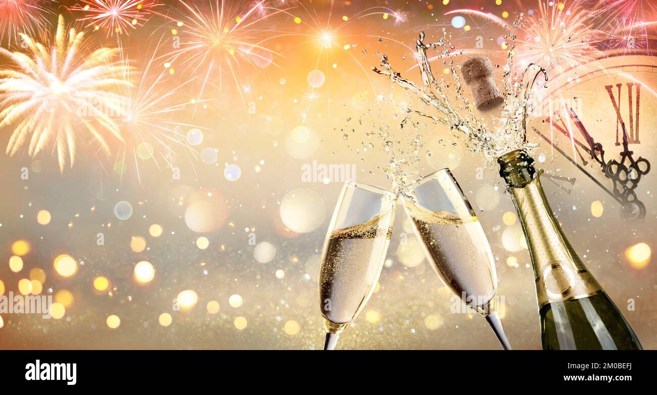 Brindisi di Capodanno con champagne e fuochi d'artificio - Festa di festa con quadrante dell'orologio con luci soffocate astratto Foto Stock