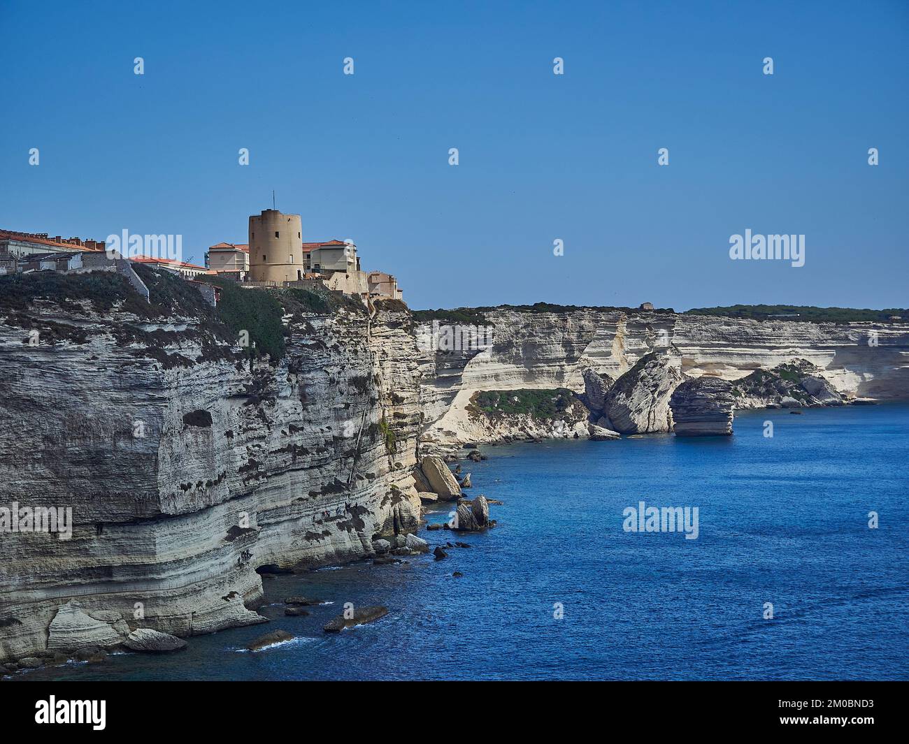 La città di Bonifacio si trova su una scogliera bianca, circondata dalle acque turchesi del mar mediterraneo sull'isola di Corsica, in Francia Foto Stock