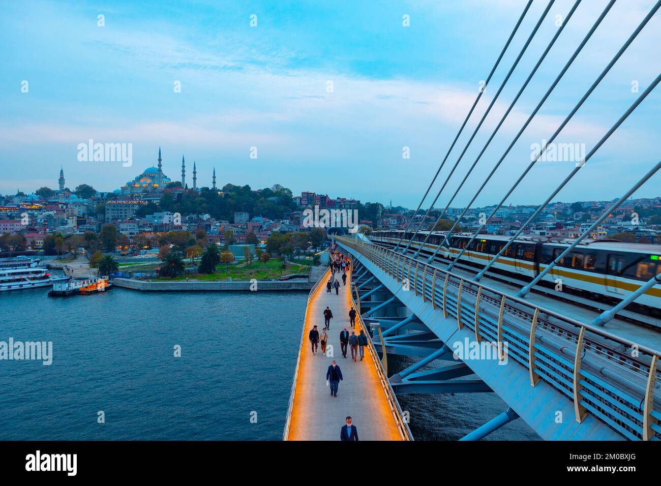Golden Horn o Halic Metro Bridge. Persone sul ponte e Moschea Suleymaniye sullo sfondo. Istanbul Turkiye - 10.15.2021 Foto Stock