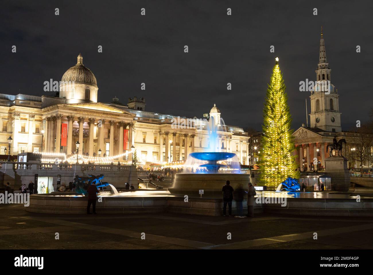 LONDRA, UK - 6th DEC 2022: Trafalgar Square a Londra a Natale. Mostra un albero di Natale, bancarelle di mercato e una fontana. Le persone possono essere viste. Foto Stock