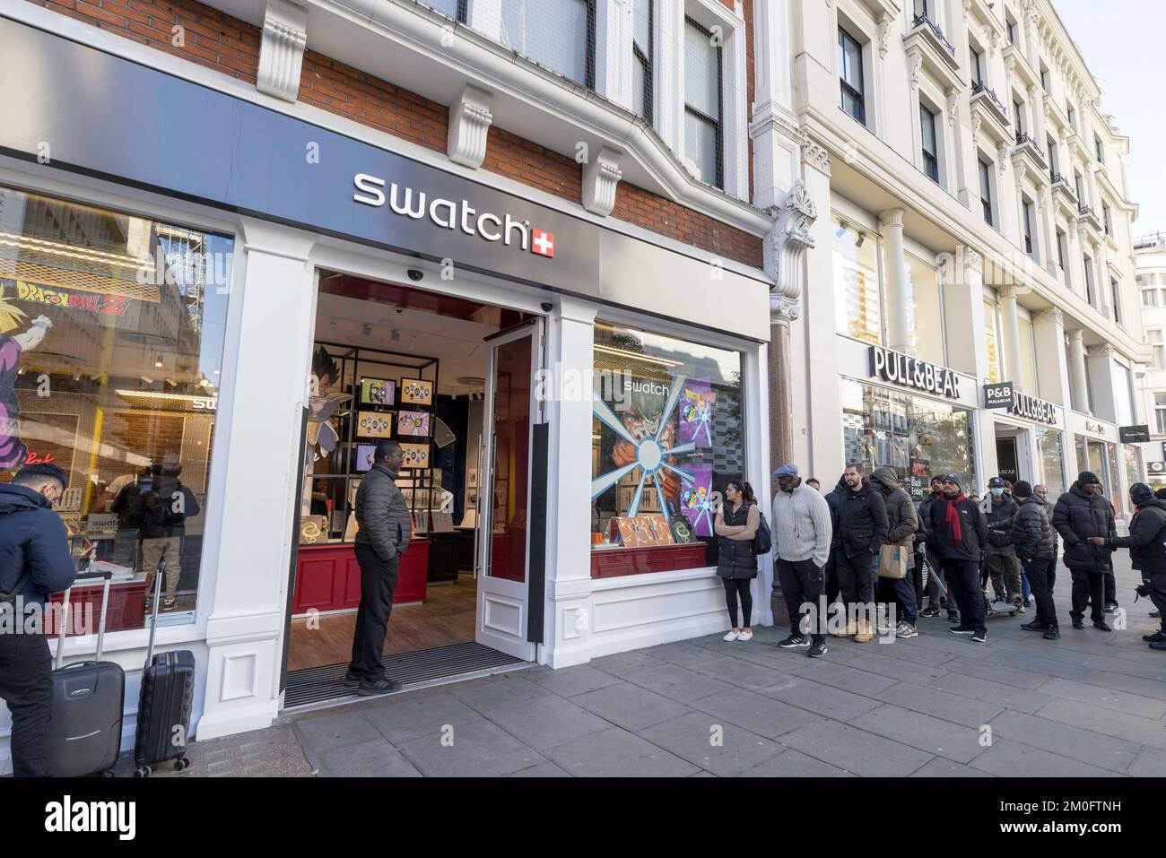 Questa mattina la gente ha visto fare la coda fuori dal negozio Swatch su Oxford Street. Gli acquirenti traggano il massimo dalla vendita annuale del Black Friday nella speranza di un serpente Foto Stock