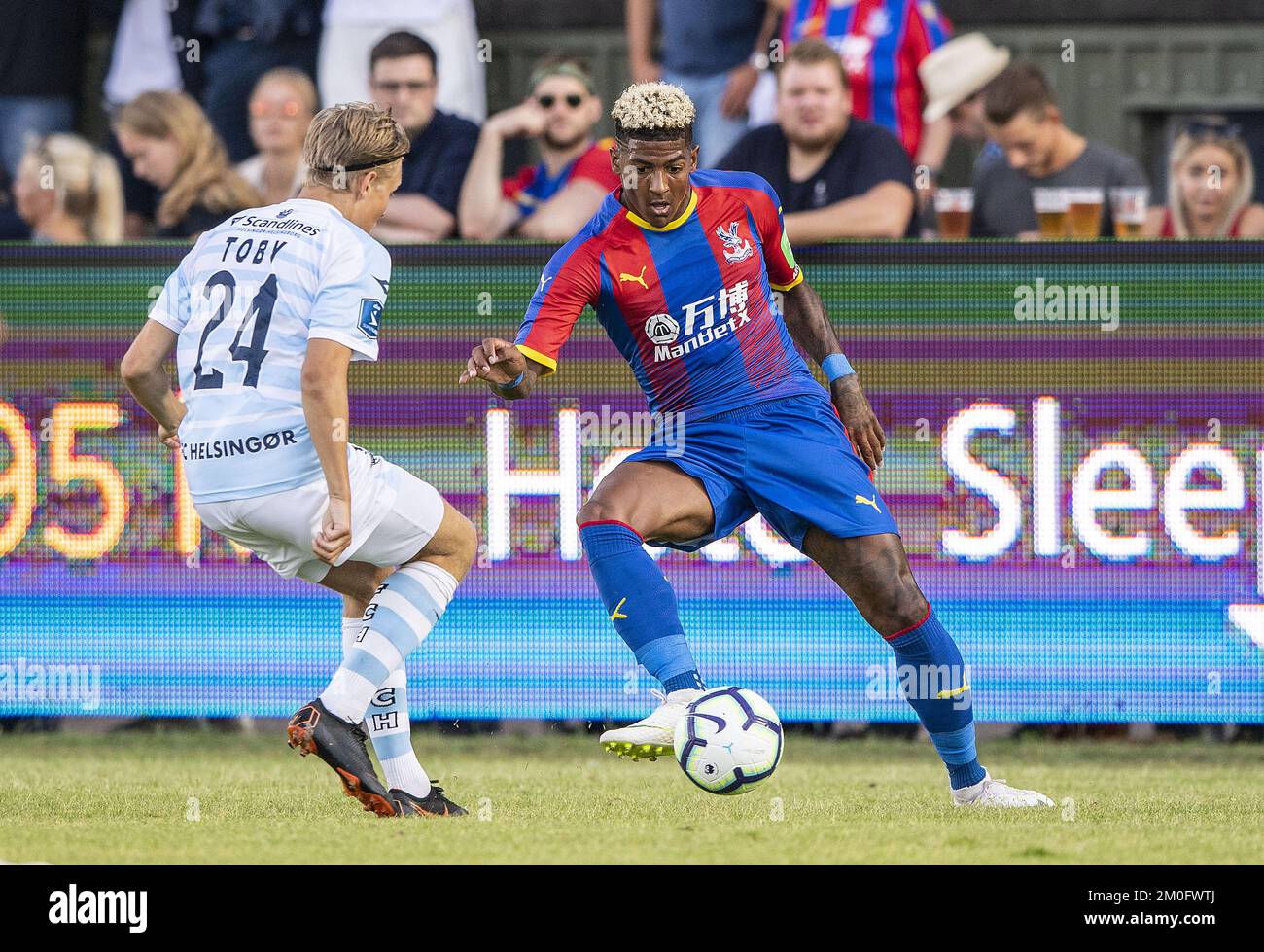 Carl Lange del FC Elsinore (a sinistra) e Patrick van Aanholt del Crystal Palace durante un amichevole il 12 luglio 2018. Foto Stock