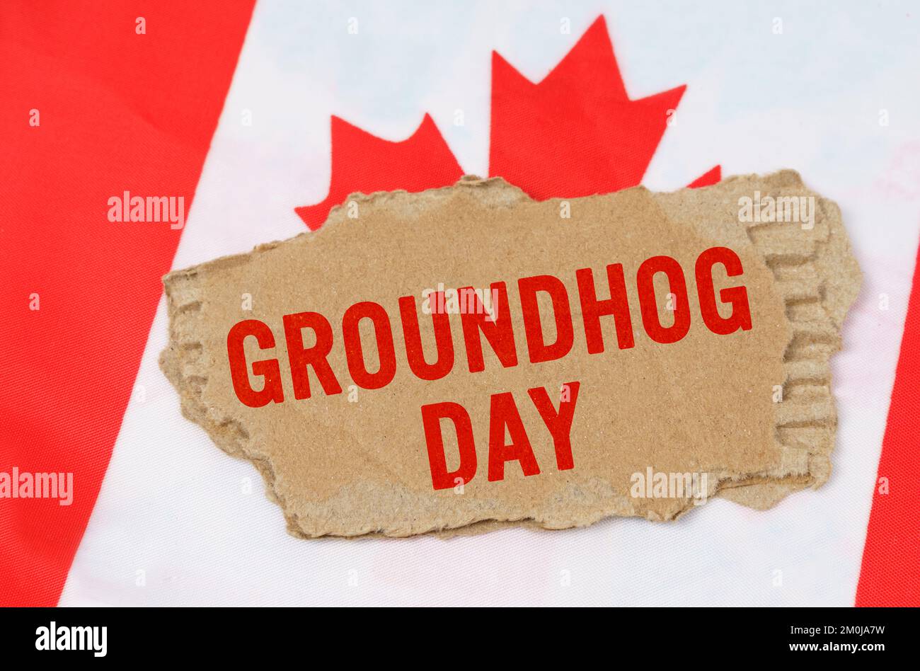 Vacanze in Canada. Sullo sfondo della bandiera del Canada si trova cartone con l'iscrizione - Groundhog Day Foto Stock