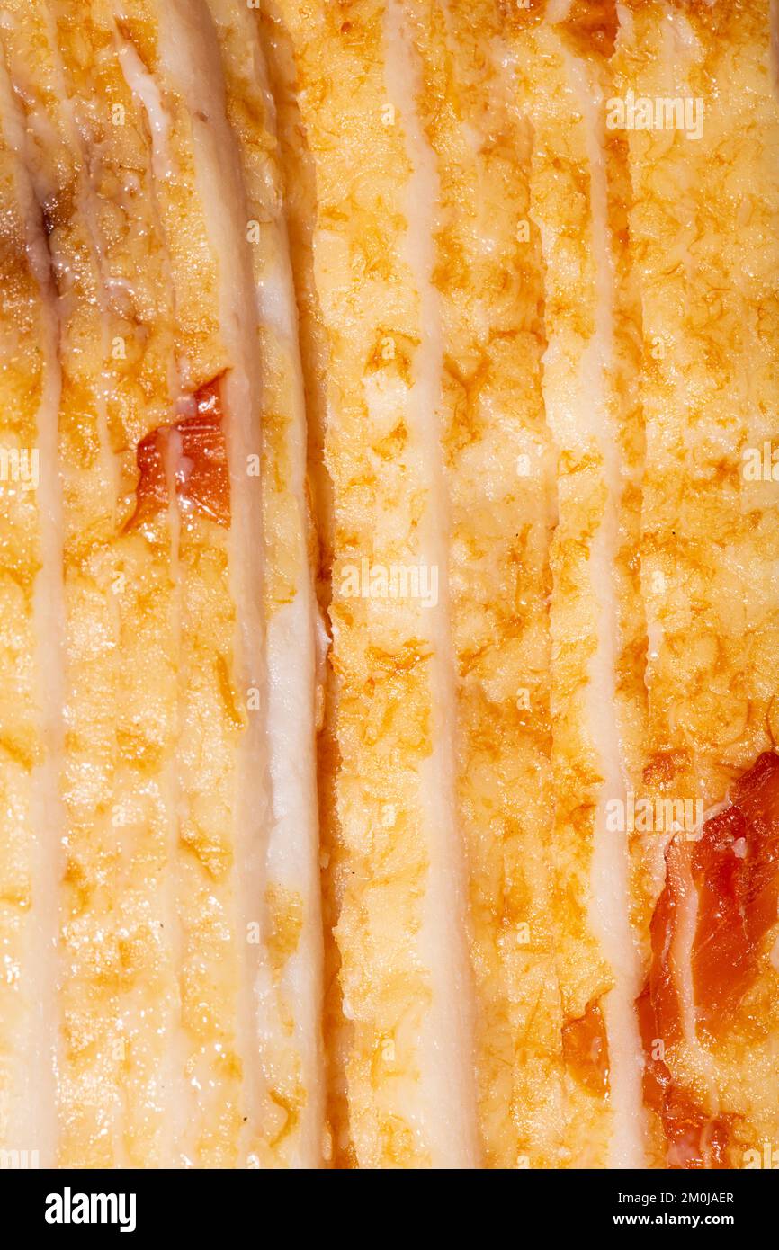 Struttura di pancetta cruda come sfondo. Un bicchierino di pancetta cruda. Macro photo.bacon. Foto Stock