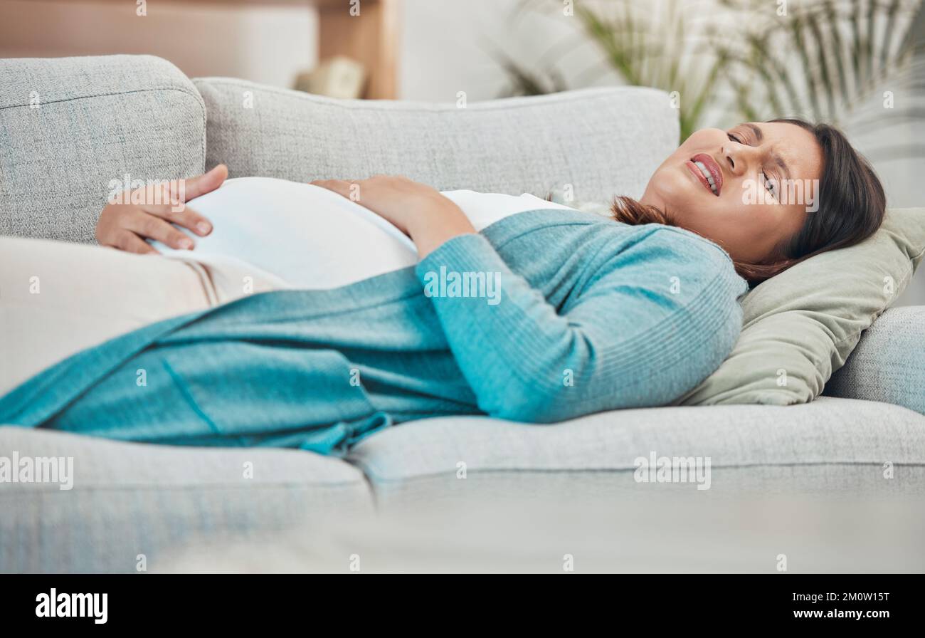 Gravidanza, dolore e donna nel lavoro con dolore allo stomaco e parto a casa di famiglia, madre nuova e gravidanza emergenza. Salute, assistenza prenatale e medica Foto Stock