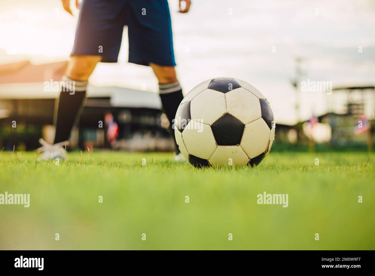Sport d'azione all'aperto dei giocatori di calcio sul cielo del tramonto. Atleta uomo jumping calcio palla per sfondo torneo di coppa del mondo. Foto Stock