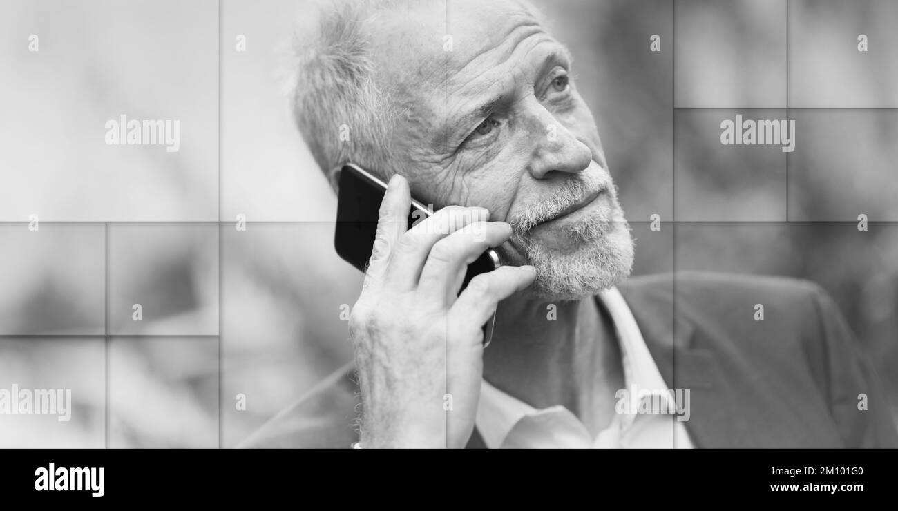 Uomo maturo che parla al telefono cellulare all'aperto, modello geometrico Foto Stock