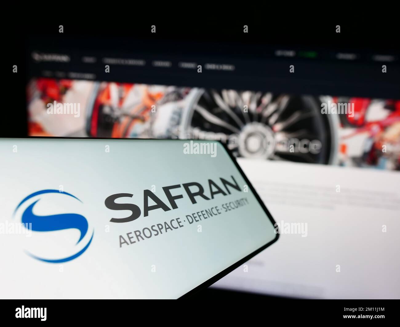 Cellulare con il logo della società aerospaziale francese Safran S.A. sullo schermo di fronte al sito web aziendale. Messa a fuoco al centro a sinistra del display del telefono. Foto Stock