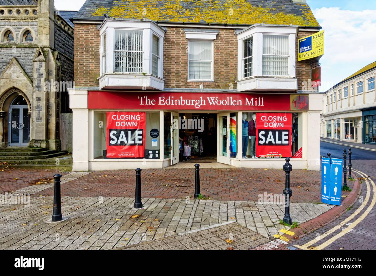 Poole, Dorset, Regno Unito - Novembre 3 2020: Poster di chiusura vendita esposti nelle vetrine del negozio di abbigliamento The Edinburgh Woollen Mill Foto Stock