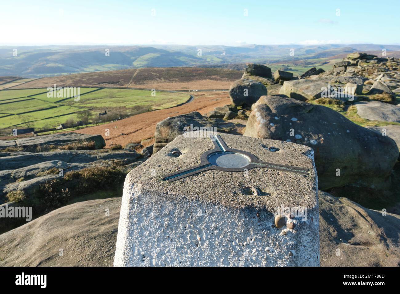 Guardando lungo Stanage Edge, Derbyshire, uno sperone roccioso popolare tra gli scalatori. Un punto di triangolazione è in primo piano. Foto Stock Guardando lungo Stanage Edge, Derbyshire, uno sperone roccioso popolare tra gli scalatori. Un punto di triangolazione è in primo piano. Foto Stock
