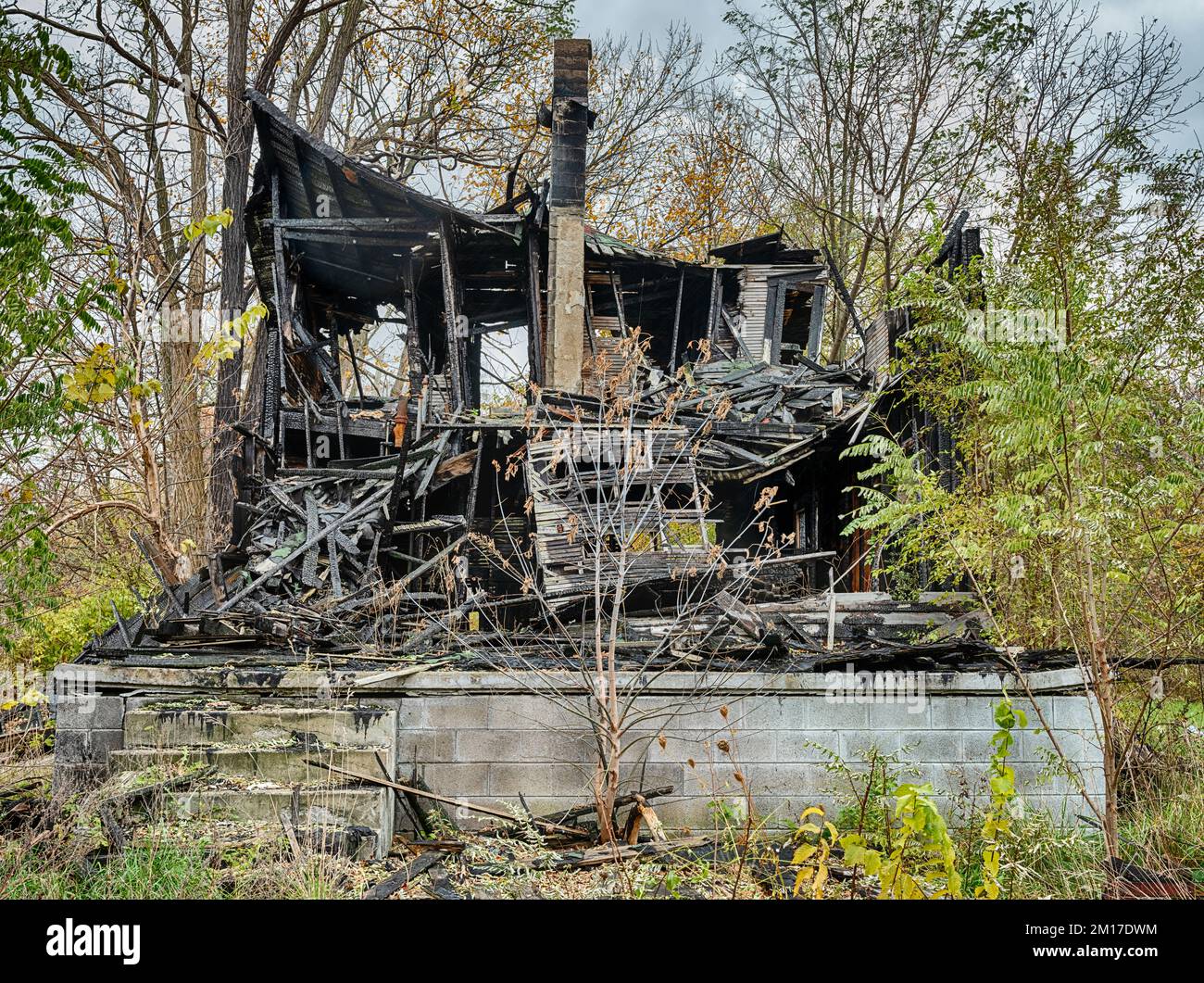 Una casa bruciata a Detroit, Michigan è arroccata su un blocco di cemento fondazione. Foto Stock