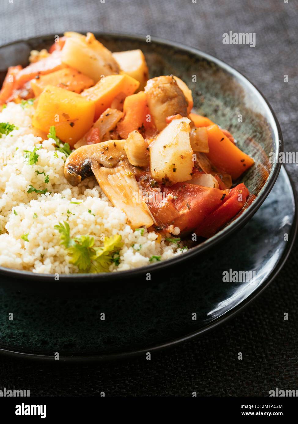Ciotola con un ragù di verdure vegane con couscous erbaceo Foto Stock