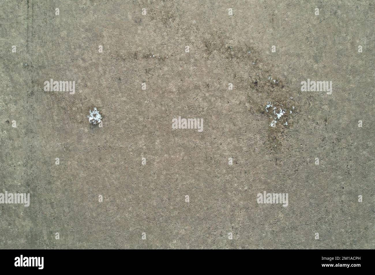 Superficie di terra marrone con l'antenna di neve fusa sopra la vista dall'alto Foto Stock