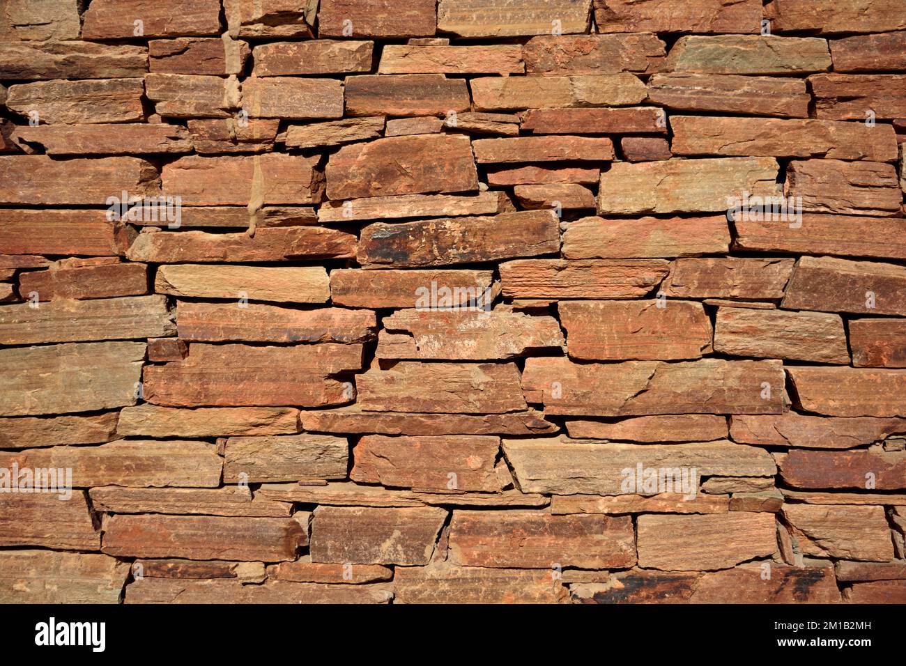 Muro di pietra. Sfondo muratura in pietra naturale arancione. Foto Stock