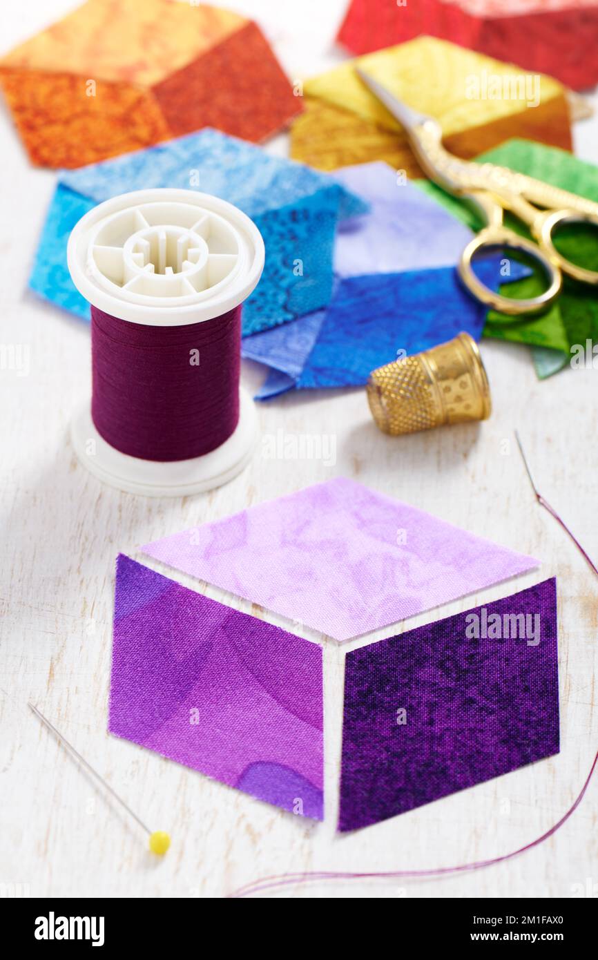 Tre diamanti, che saranno cuciti sotto forma di cubo, che costituirà la base della futura trapunta a mosaico. Foto Stock
