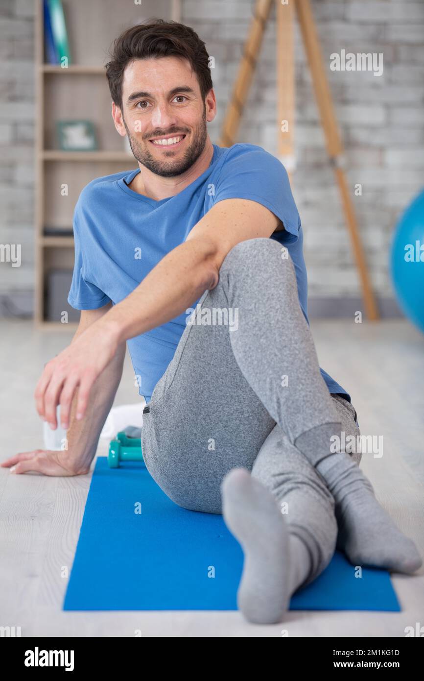 uomo sportivo e consapevole con meditare da solo a casa Foto Stock