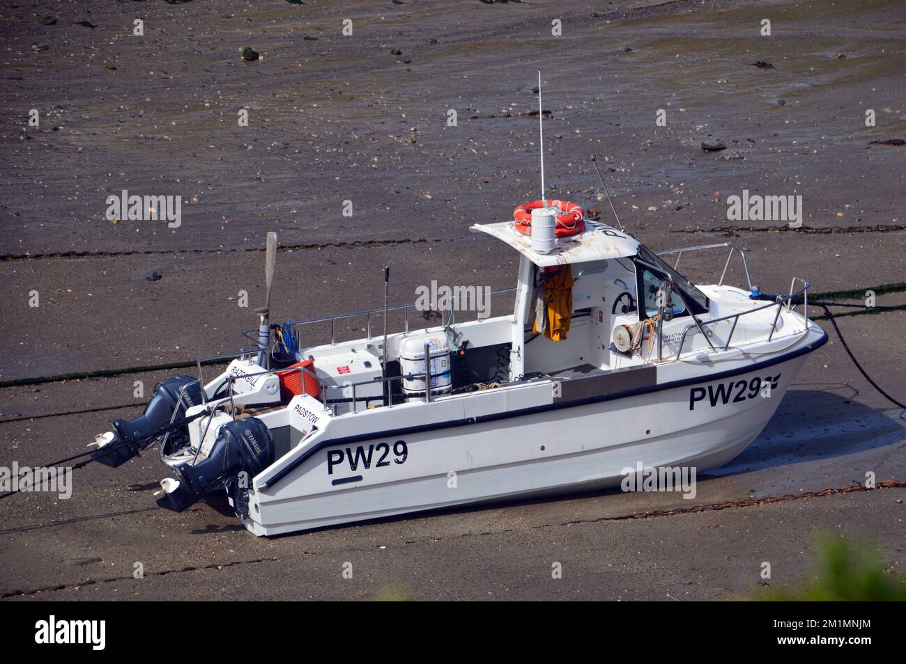 Singola piccola barca da pesca nel porto del piccolo villaggio di Port Isaac sul South West Coastal Path, Cornovaglia, Inghilterra, Regno Unito. Foto Stock