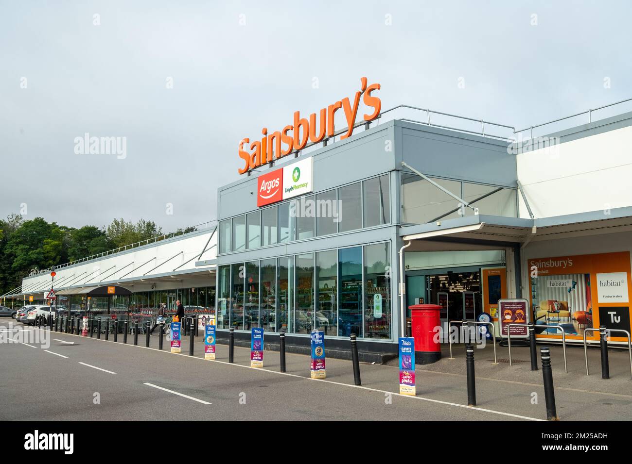 Basingstoke, Regno Unito - Settembre 2022: Ingresso di Sainsbury con l'insegna della farmacia Argos e Lloyds - la principale catena di supermercati britannica Foto Stock