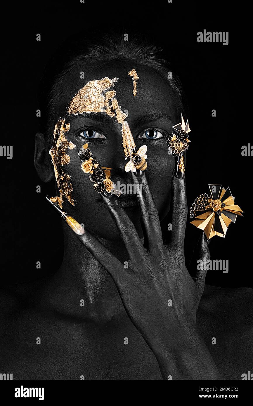 Bella donna con nero arte trucco, creative unghie lunghe. Manicure di disegno. Bellezza viso. Foto Stock