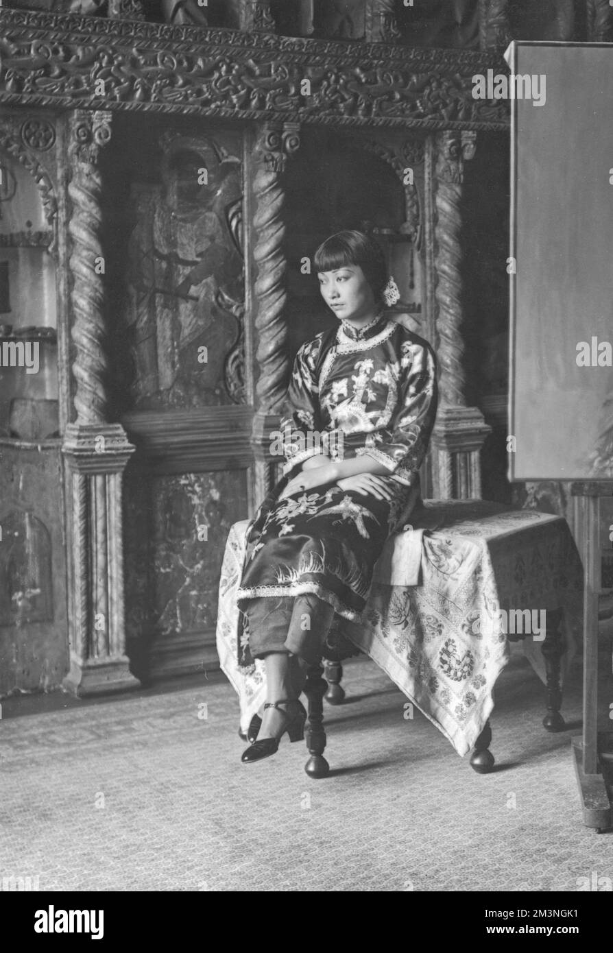 Ritratto di Anna May Wong, attrice cinematografica cinese americana (1905 - 1961) raffigurato in un abito tradizionale cheongsam che guarda riflettente. Data: c.1930 Foto Stock