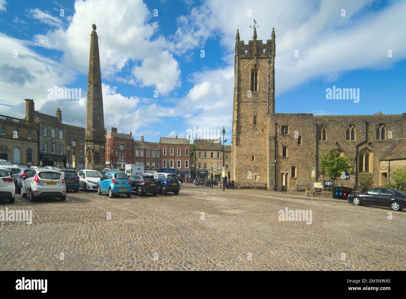 Richmond; antico centro cittadino acciottolato. Guardando a nord, l'Obelisco e la Chiesa della Santissima trinità, Richmond, North Yorkshire Inghilterra Regno Unito Foto Stock