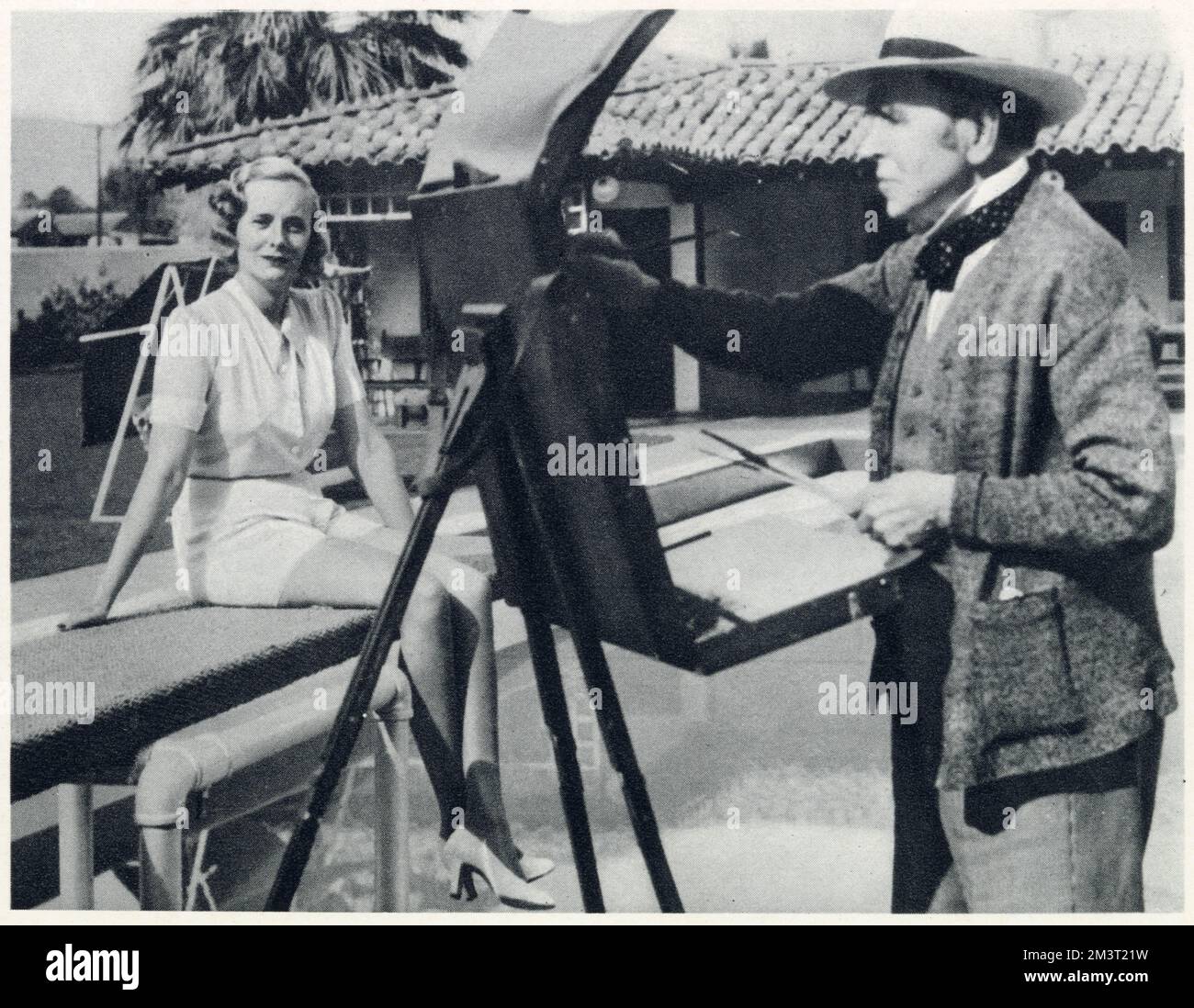 Sir John Lavery al suo cavalletto a Palm Springs, dipingendo Doris Delavigne, Lady Castlerosse, seduto su un trampolino. Foto Stock
