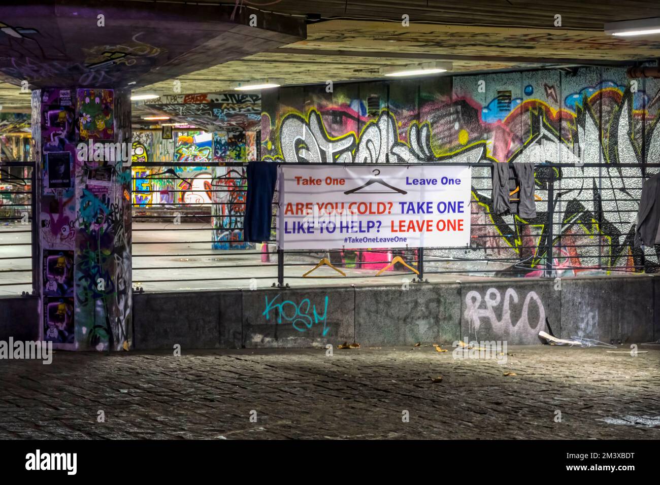 Prendi un abbigliamento da lasciare per i senzatetto e le traversine grezze al South Bank undercroft skatepark di Londra. Foto Stock