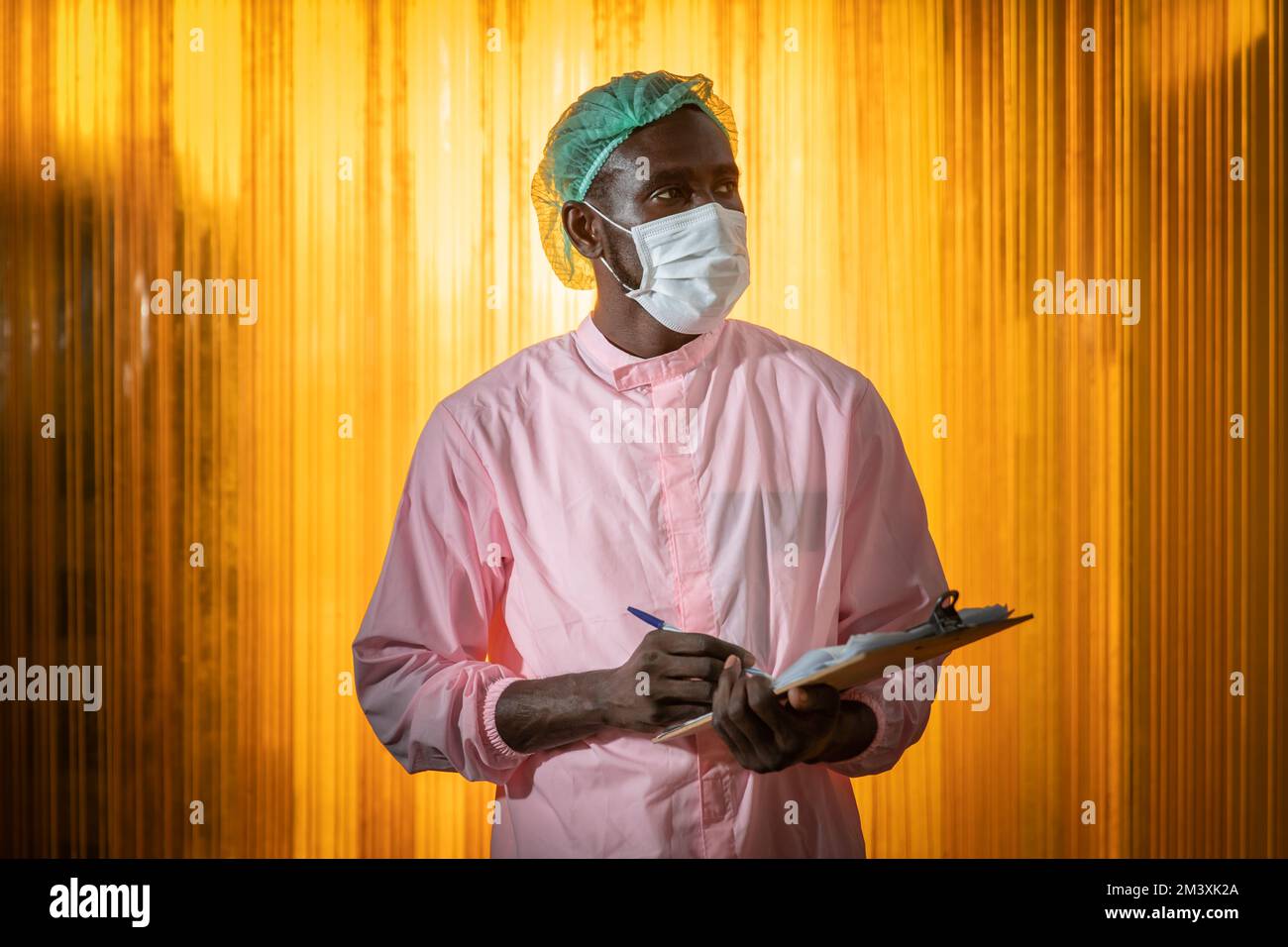 Lavoratore nero africano in alimenti e bevande igiene personale ufficiale a piedi controllare la qualità dei prodotti in fabbrica. Foto Stock